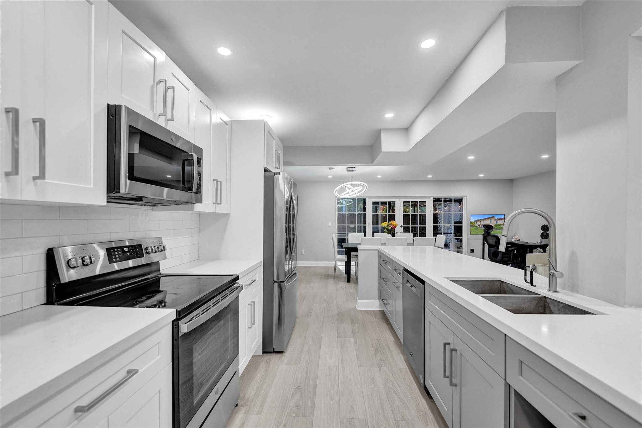 3301 Raleigh Street, Unit 4B Hollywood, FL 33021 - Photo 10 of 54 a kitchen with counter top space stainless steel appliances and cabinets