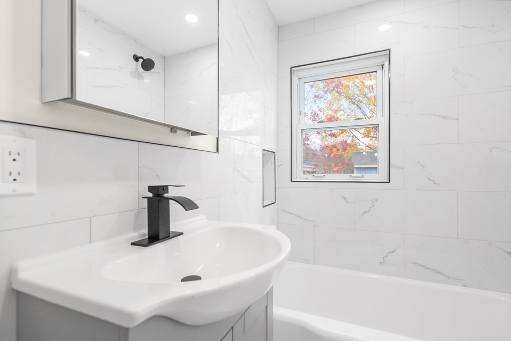 25 Lakeview Street Blackstone, MA 01504 - Photo 11 of 26 a bathroom with a sink and a window