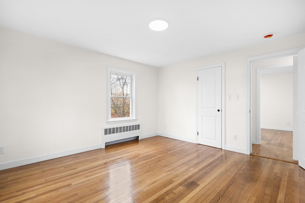 25 Lakeview Street Blackstone, MA 01504 - Photo 14 of 26 an empty room with wooden floor and windows