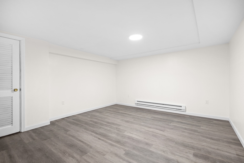 25 Lakeview Street Blackstone, MA 01504 - Photo 17 of 26 an empty room with wooden floor and windows