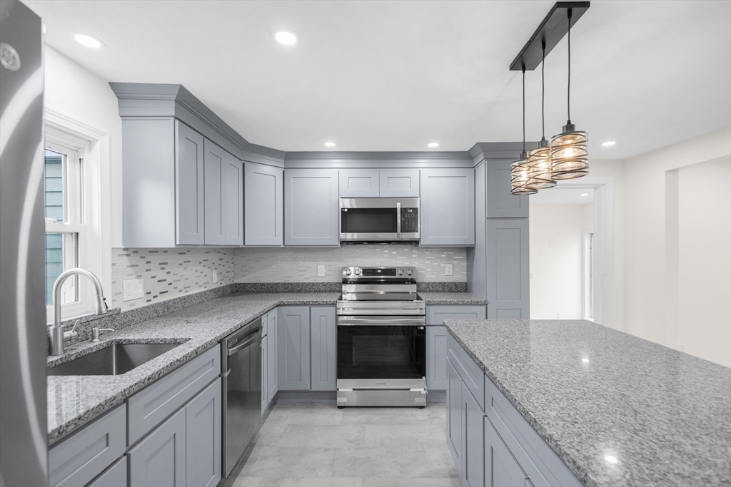 25 Lakeview Street Blackstone, MA 01504 - Photo 2 of 26 a kitchen with a sink stove and microwave