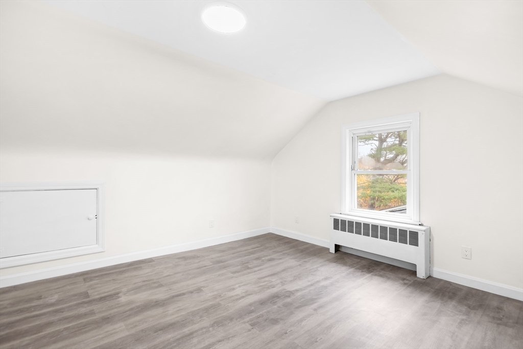 25 Lakeview Street Blackstone, MA 01504 - Photo 8 of 26 an empty room with wooden floor and windows