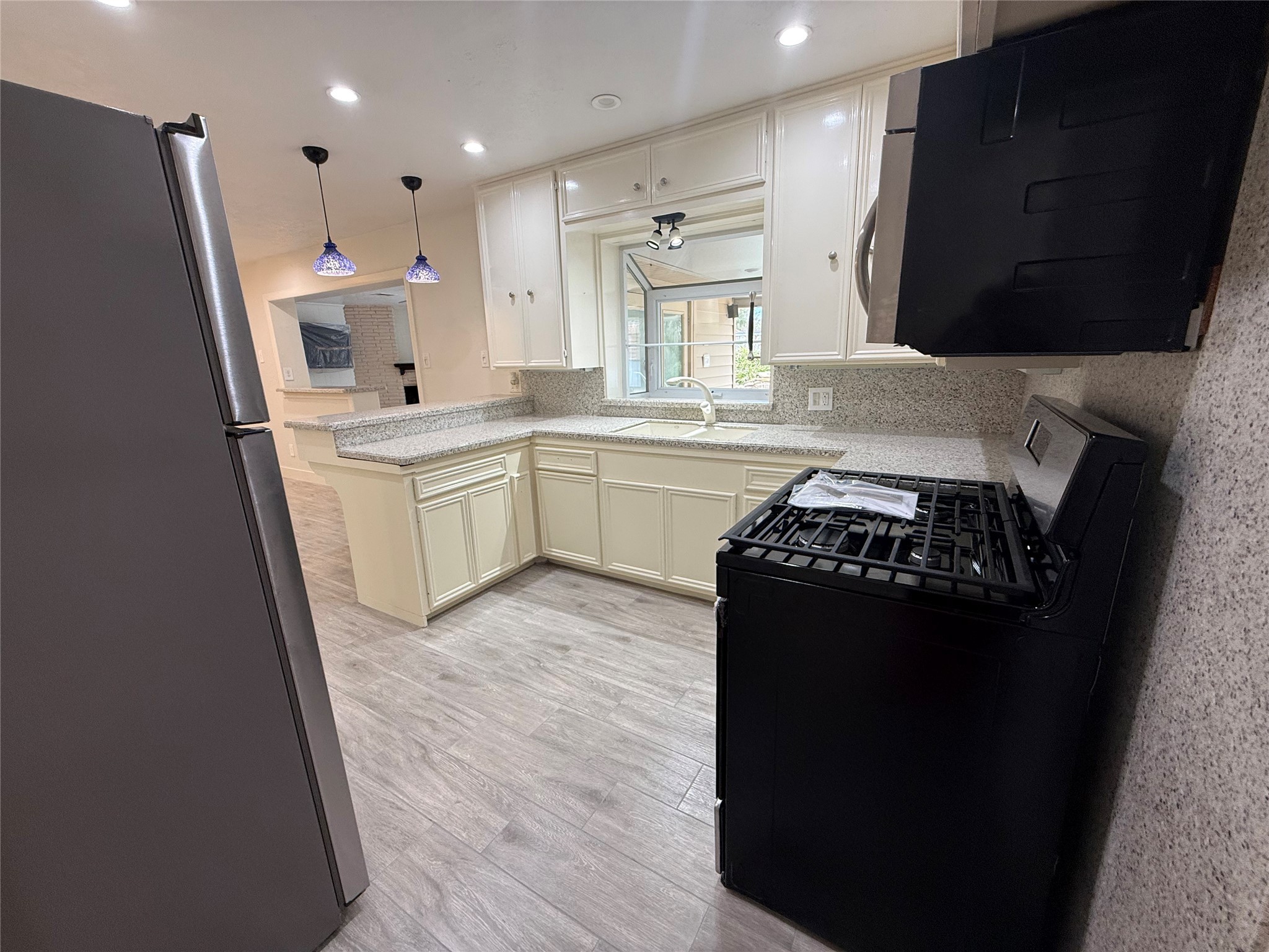 822 Hidden Valley Drive Houston, TX 77088 - Photo 15 of 48 a kitchen with a sink a stove and refrigerator