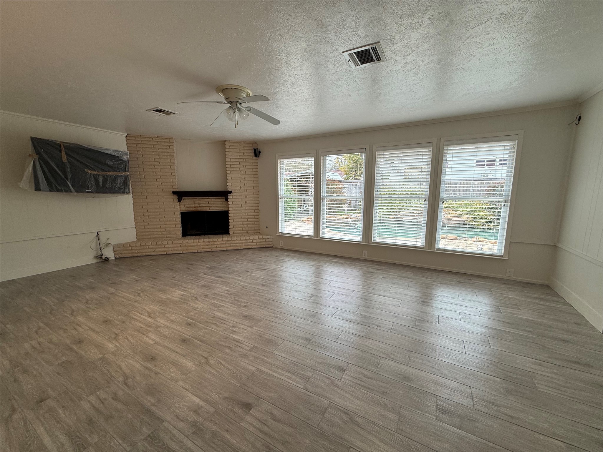 822 Hidden Valley Drive Houston, TX 77088 - Photo 19 of 48 an empty room with windows and fireplace