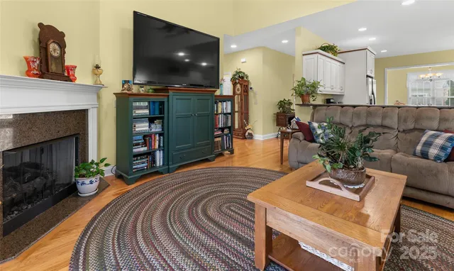 a living room with fireplace furniture and a flat screen tv