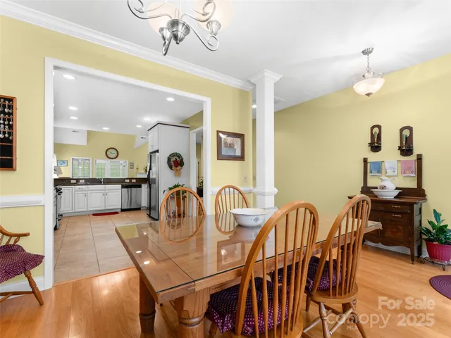 a dining room with furniture and wooden floor