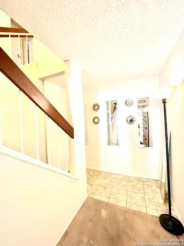 a view of a big room with wooden floor and windows