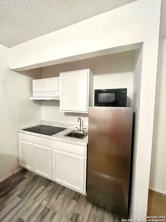 a kitchen with stainless steel appliances a white stove top oven and sink