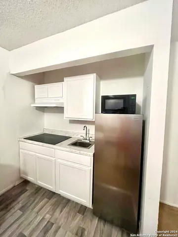 a kitchen with stainless steel appliances a white stove top oven and sink