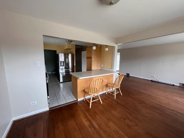 a dining room with furniture and wooden floor