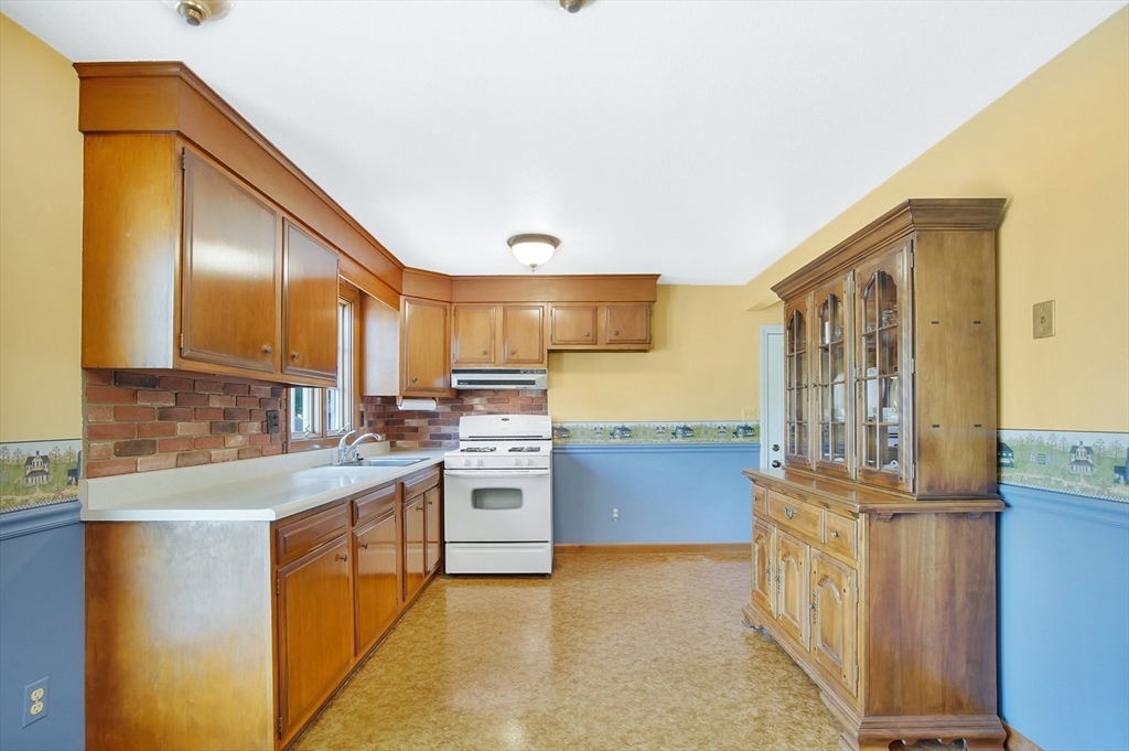 100 Penncastle Street Springfield, MA 01129 - Photo 10 of 26 a kitchen with stainless steel appliances granite countertop a stove a sink and a refrigerator
