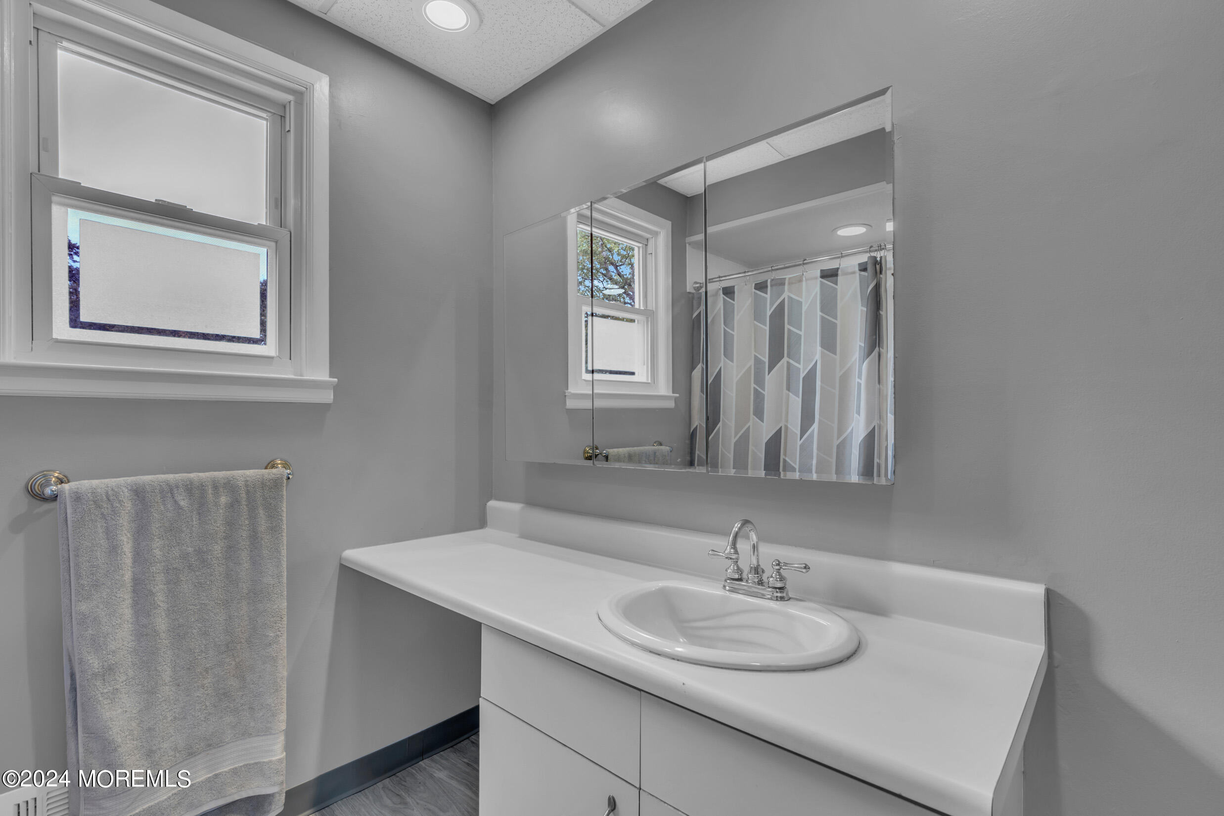 1126 Toms River Road Jackson, NJ 08527 - Photo 16 of 38 a bathroom with a sink and a mirror