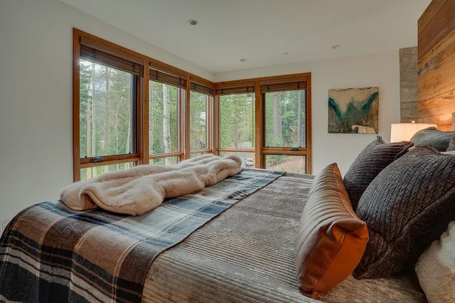 a bedroom with two beds and a large window