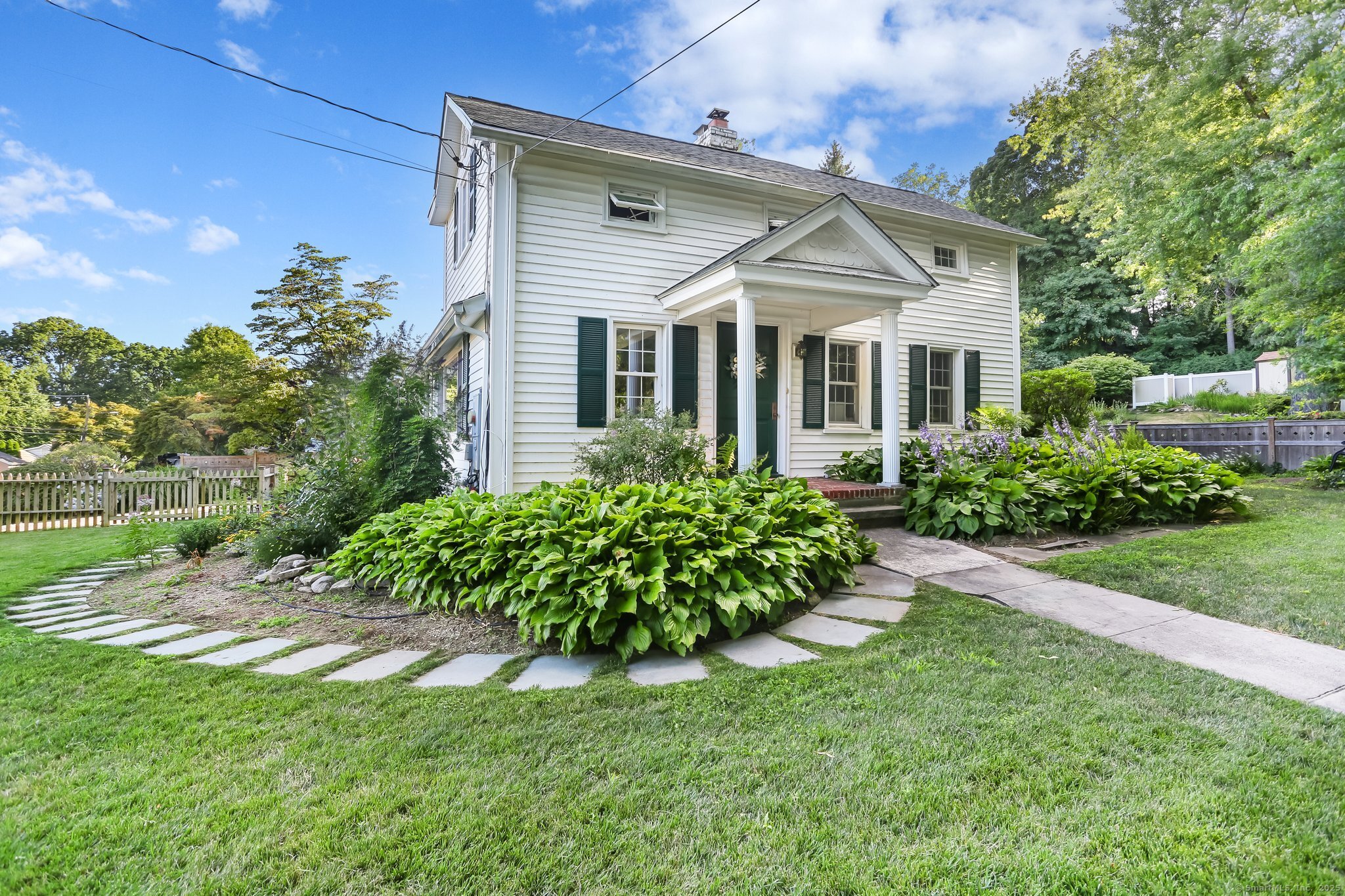 Charming w/beautiful landscaping & deep lawn