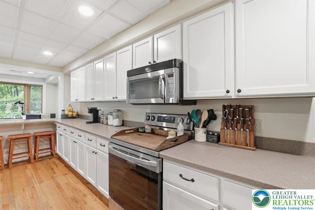 3585 Fairyland Road Lehighton, PA 18235 - Photo 23 of 57 a kitchen with stainless steel appliances granite countertop a stove a sink and a microwave