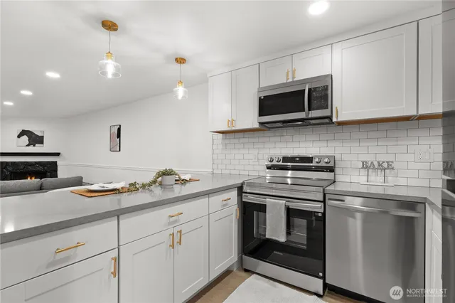 a kitchen with stainless steel appliances granite countertop a sink and a stove