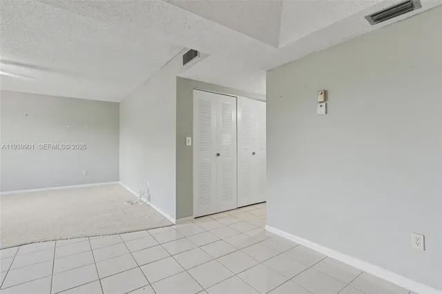 a kitchen with granite countertop a sink a counter top space stainless steel appliances and cabinets