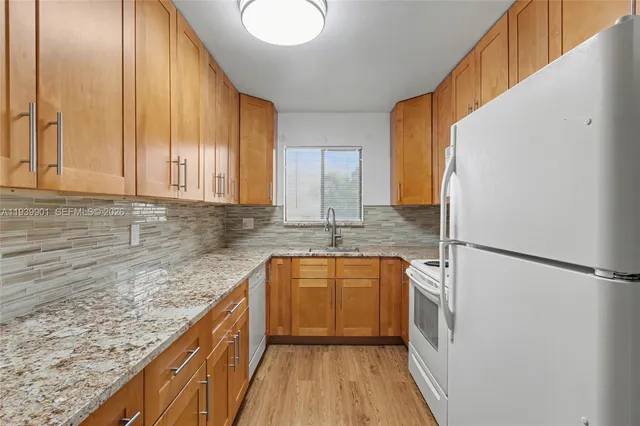 a kitchen with stainless steel appliances granite countertop a sink and cabinets