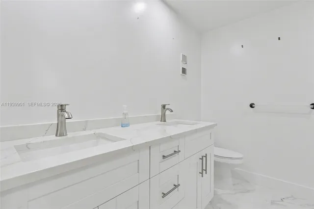 an empty room with a chandelier fan