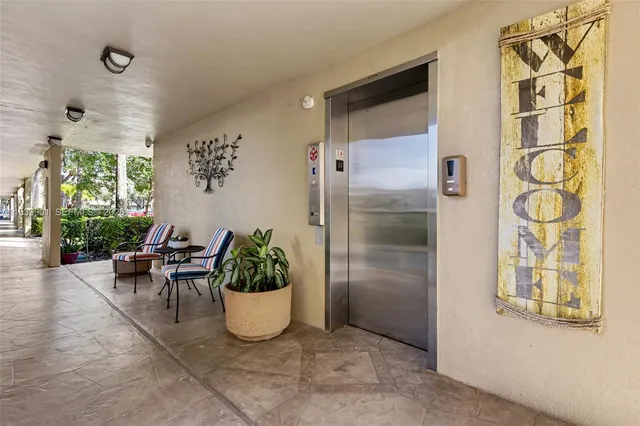 a dining room with furniture and a potted plant