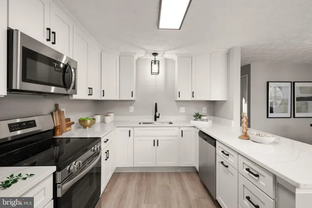 a kitchen with a sink stove and cabinets