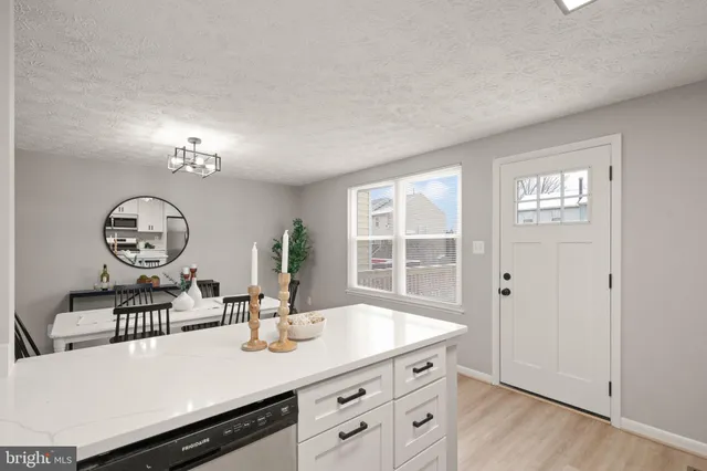 a kitchen with a sink cabinets and window