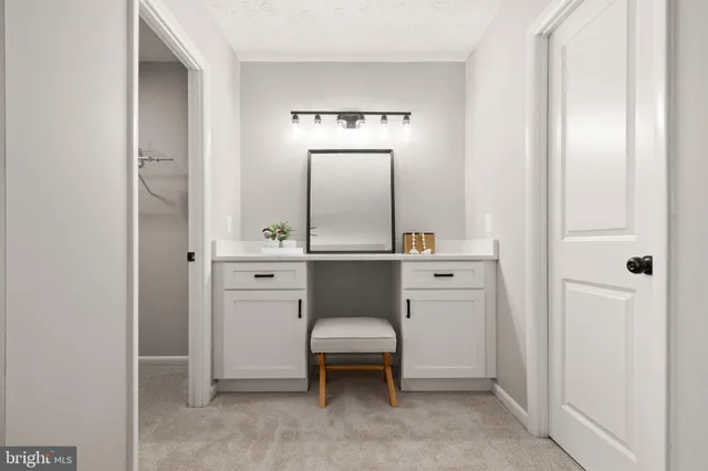 a room with a chair and white cabinet