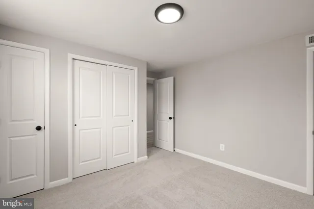 a bathroom with a toilet a sink a mirror a bathtub and vanity