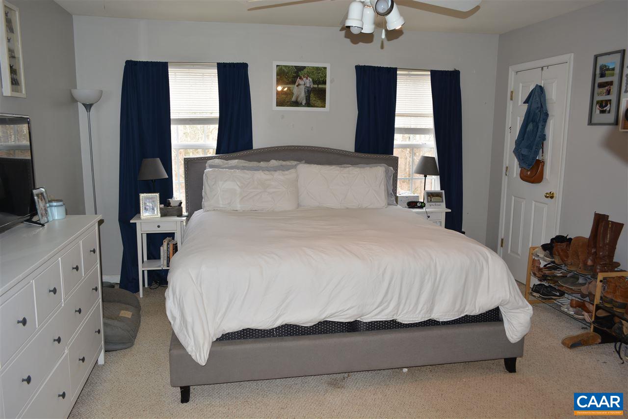 1 Riverside Drive Palmyra, VA 22963 - Photo 11 of 26 a bedroom with a bed and a flat tv screen on dresser