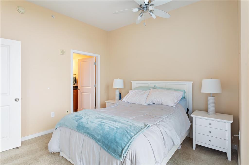 3300 Windy Ridge Parkway Southeast, Unit 713 Atlanta, GA 30339 - Photo 12 of 35 a bedroom with a bed and a night stand