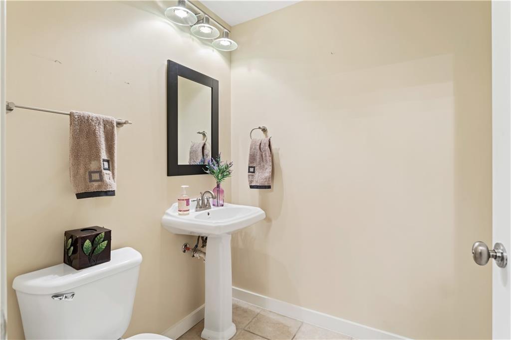 3300 Windy Ridge Parkway Southeast, Unit 713 Atlanta, GA 30339 - Photo 17 of 35 a bathroom with a toilet sink and mirror
