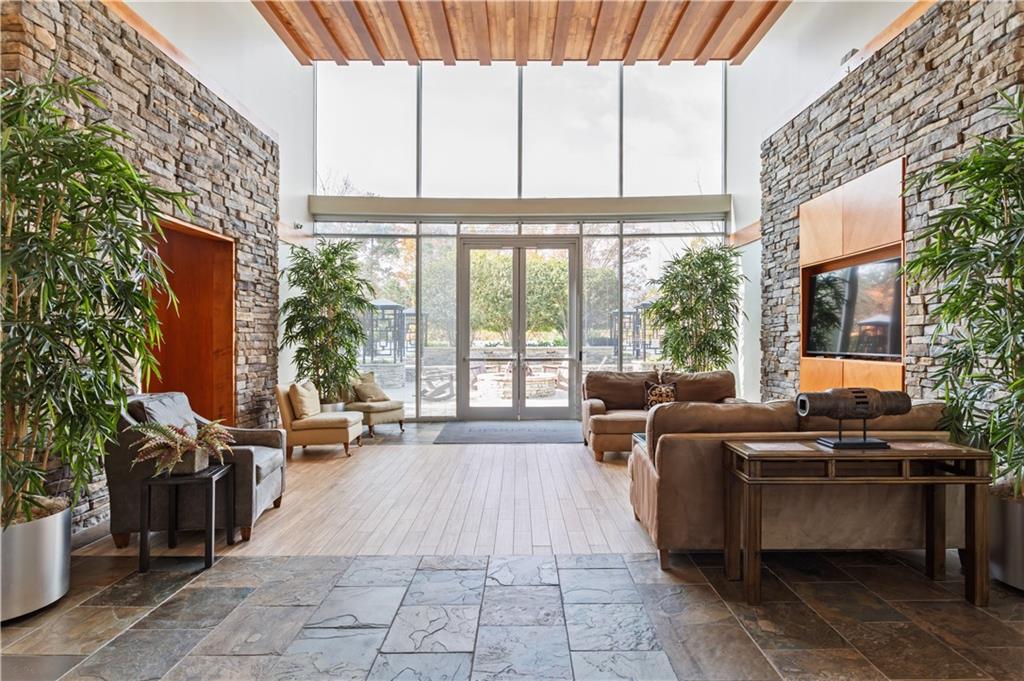 3300 Windy Ridge Parkway Southeast, Unit 713 Atlanta, GA 30339 - Photo 20 of 35 a living room with patio furniture and a floor to ceiling window