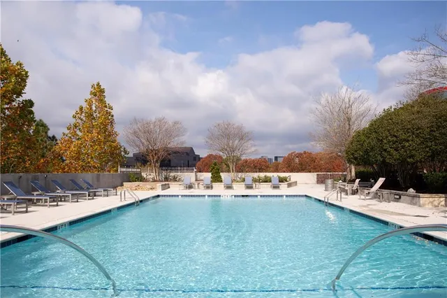 a view of a patio with table and chairs with barbeque and wooden fence