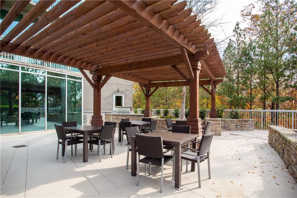 3300 Windy Ridge Parkway Southeast, Unit 713 Atlanta, GA 30339 - Photo 24 of 35 a view of a dinning table and chairs in the patio