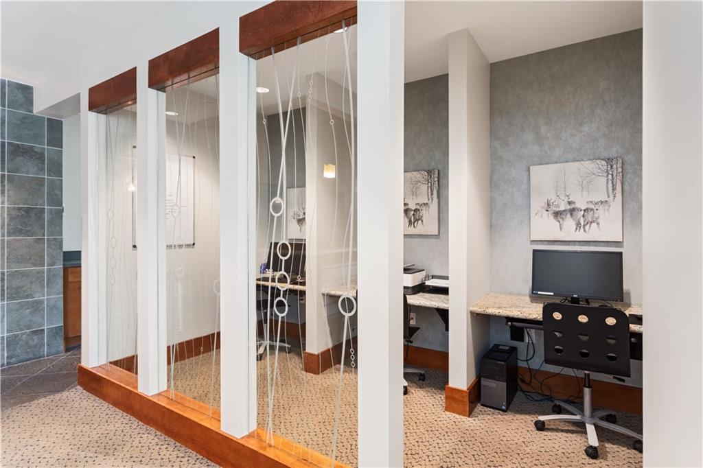 3300 Windy Ridge Parkway Southeast, Unit 713 Atlanta, GA 30339 - Photo 28 of 35 a view of a hallway and a livingroom with wooden floor and furniture