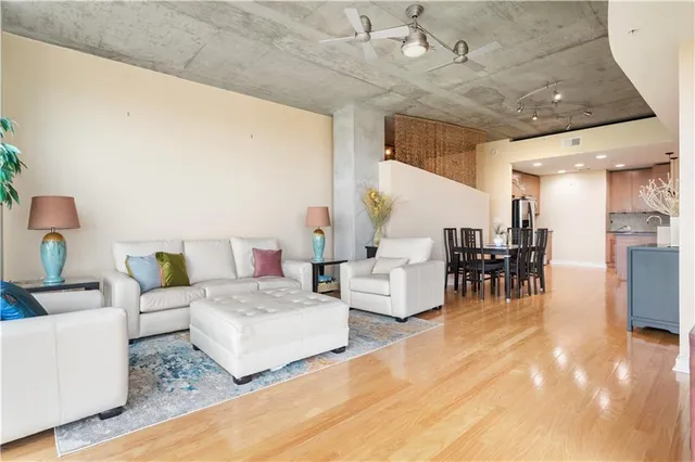 a living room with furniture and kitchen view