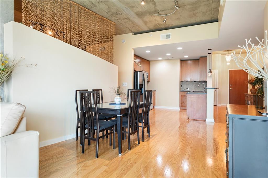 3300 Windy Ridge Parkway Southeast, Unit 713 Atlanta, GA 30339 - Photo 6 of 35 a view of a dining area with furniture and wooden floor