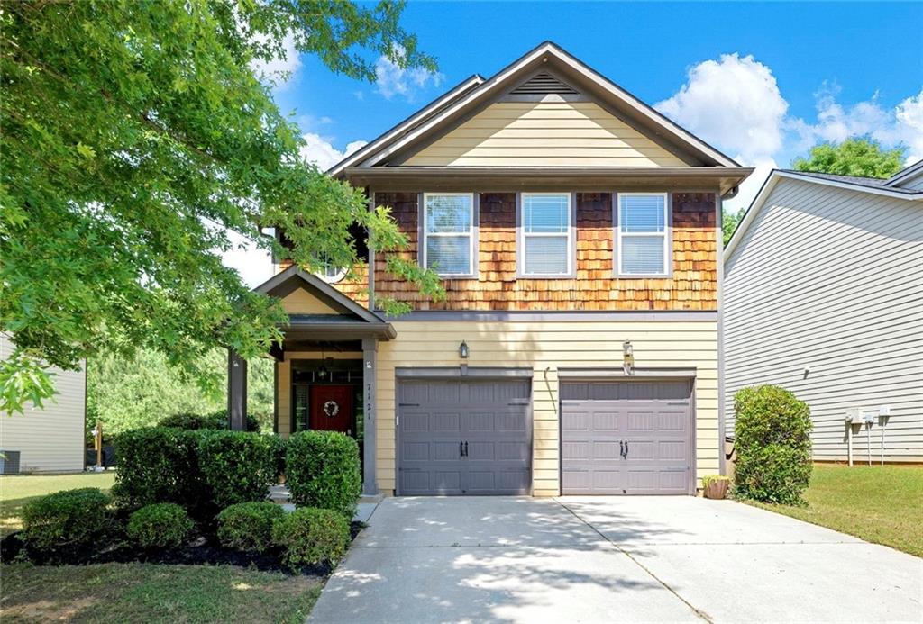 7121 Silk Tree Pointe Braselton, GA 30517 - Photo 1 of 1 a front view of a house with yard and trees
