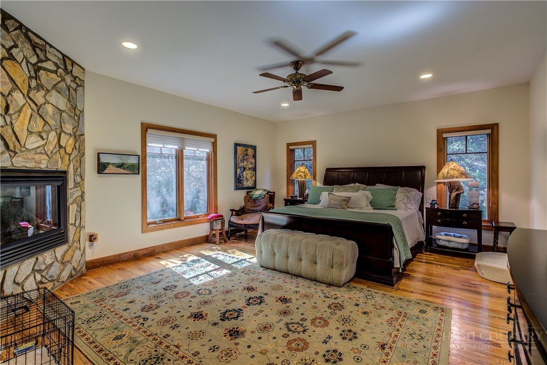 119 Blackberry Lane Boone, NC 28607 - Photo 17 of 41 a spacious bedroom with a bed a dresser and wooden floor