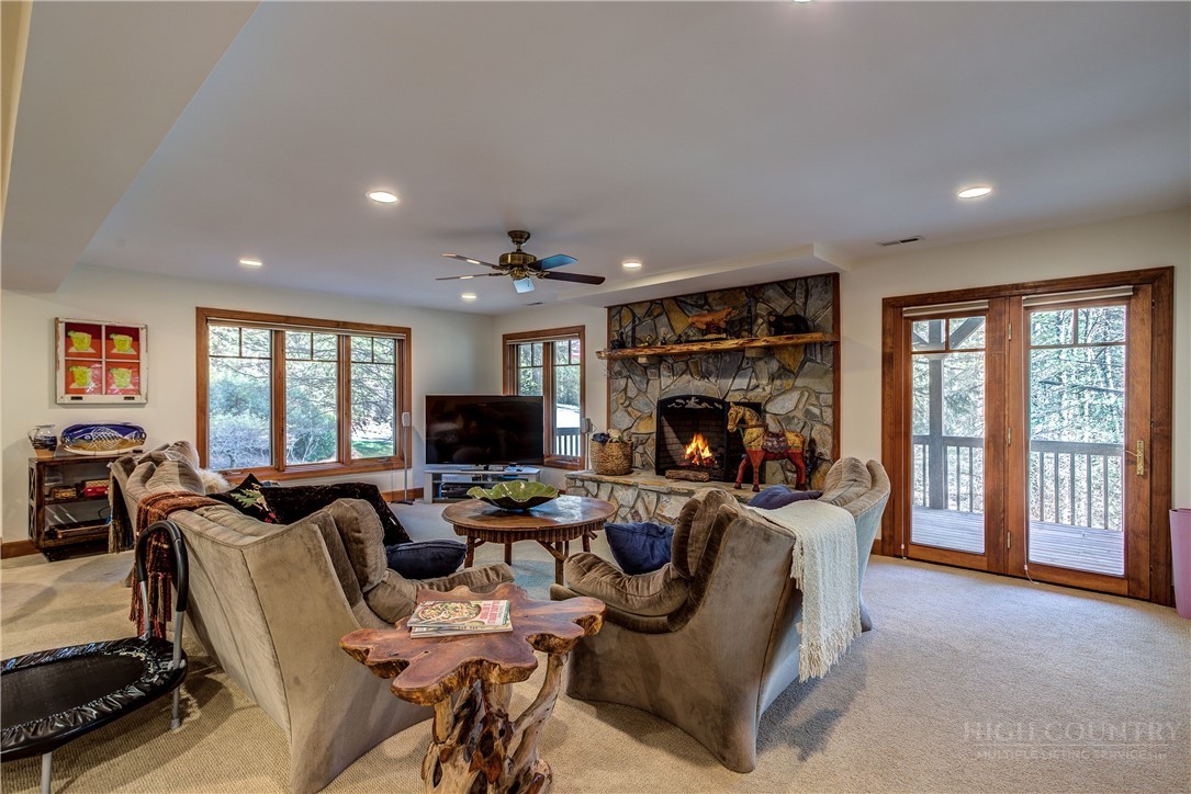 119 Blackberry Lane Boone, NC 28607 - Photo 26 of 41 a living room with furniture a flat screen tv and a fireplace