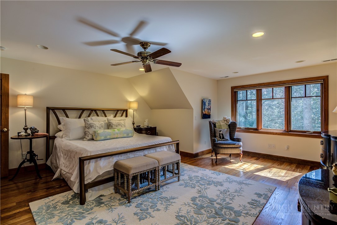 119 Blackberry Lane Boone, NC 28607 - Photo 28 of 41 a bedroom with a bed a table and chair