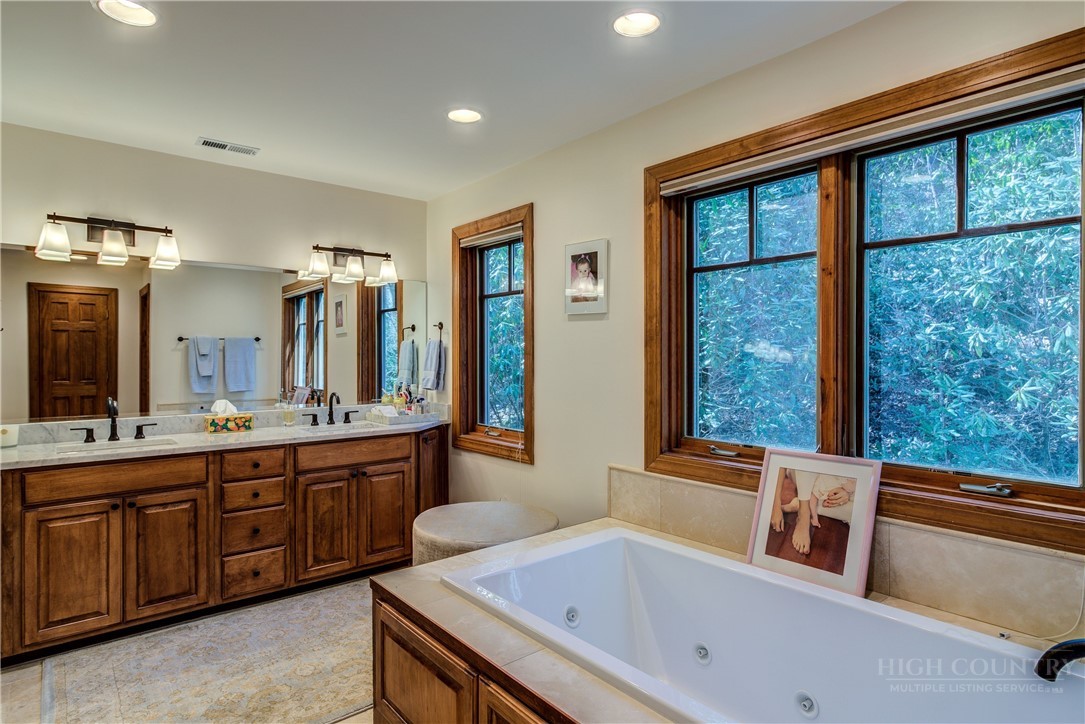119 Blackberry Lane Boone, NC 28607 - Photo 30 of 41 a bathroom with a tub sink and mirror