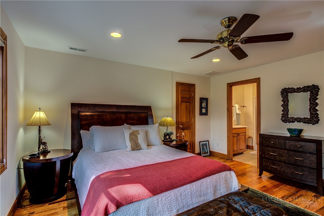 119 Blackberry Lane Boone, NC 28607 - Photo 36 of 41 a bedroom with a bed and wooden floor