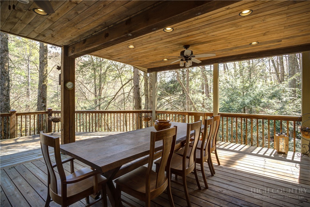 119 Blackberry Lane Boone, NC 28607 - Photo 39 of 41 a view of a patio with a table chairs and wooden floor