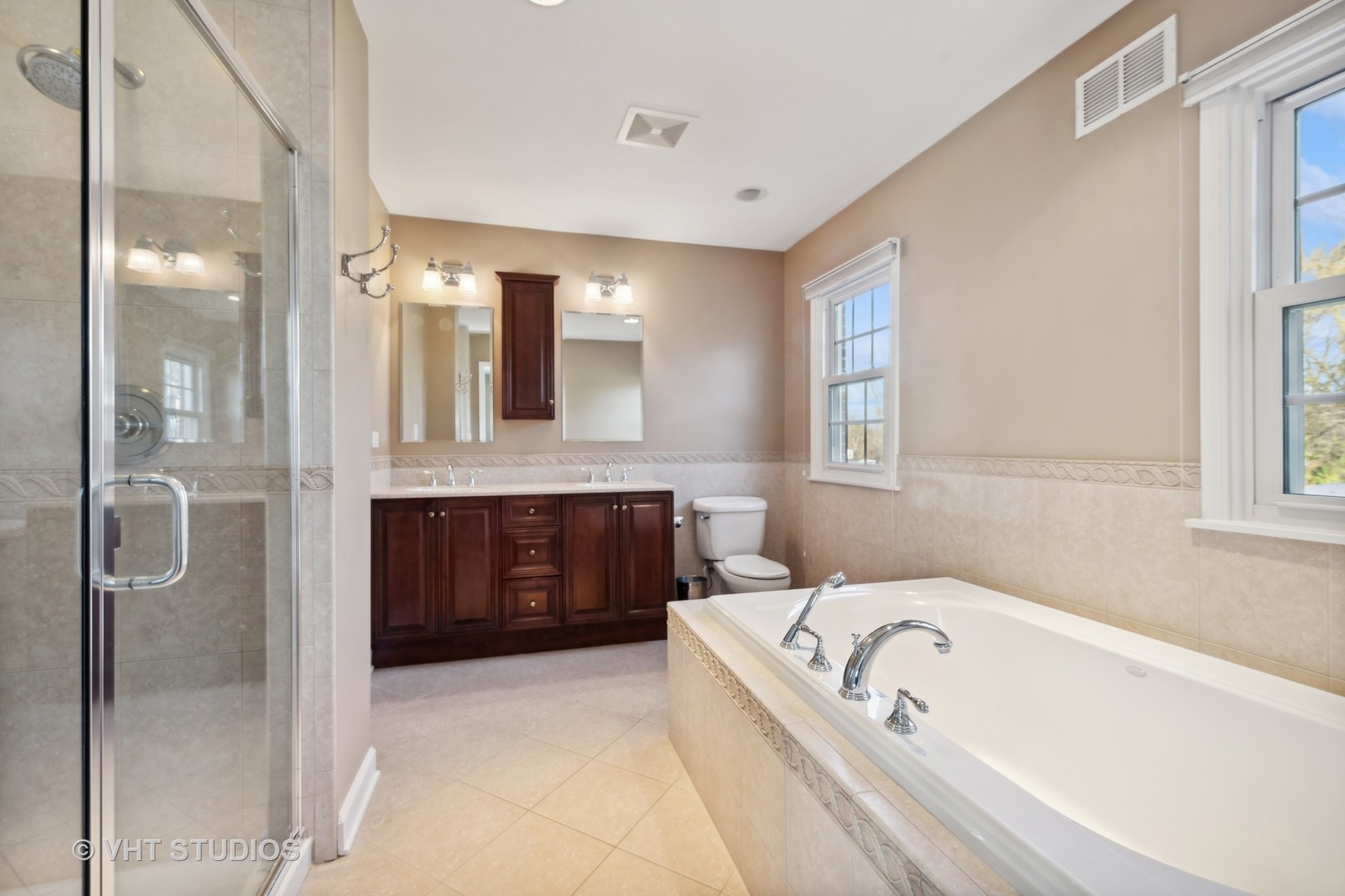 255 Cold Spring Road Barrington, IL 60010 - Photo 23 of 47 a bathroom with a tub a double vanity sink and mirror