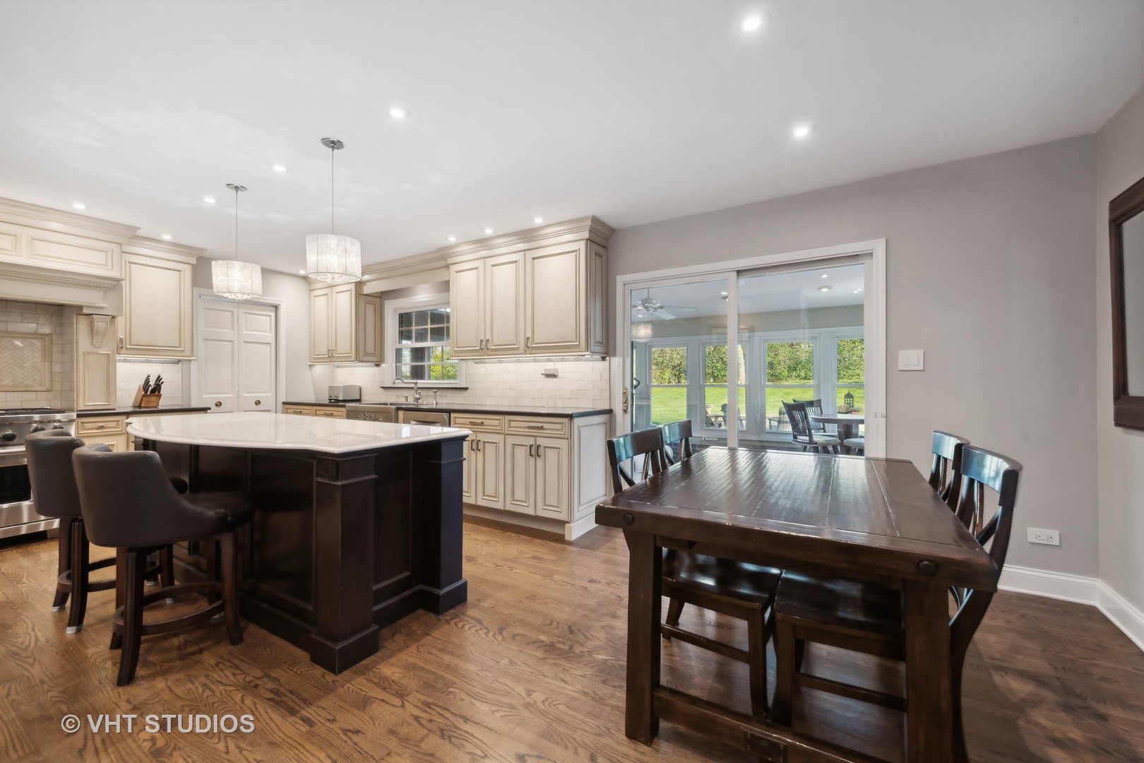 255 Cold Spring Road Barrington, IL 60010 - Photo 8 of 47 a kitchen with a dining table chairs and white cabinets
