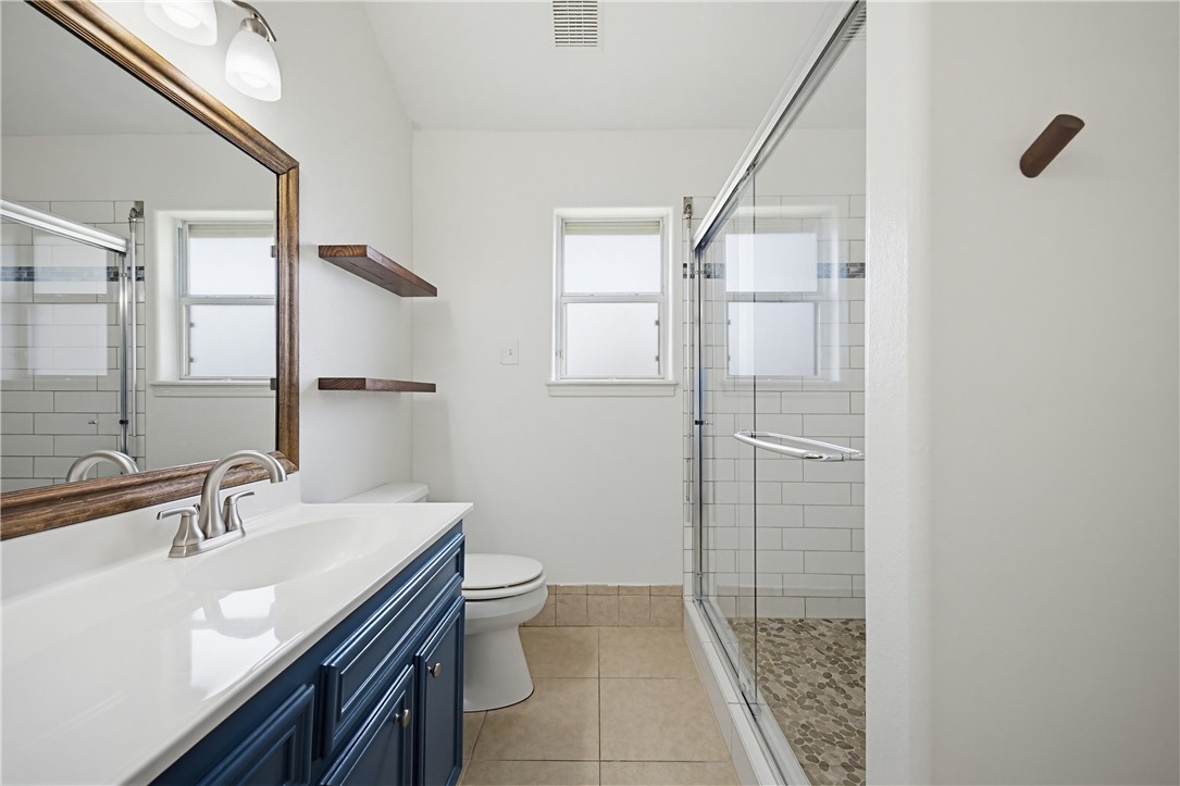 7251 Prairie Drive, Unit 6 Corpus Christi, TX 78413 - Photo 23 of 28 a bathroom with a sink a toilet and shower