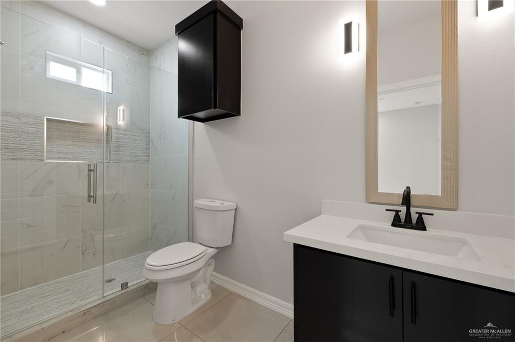 4204 Hummingbird Avenue McAllen, TX 78504 - Photo 13 of 13 a bathroom with a sink a toilet and shower