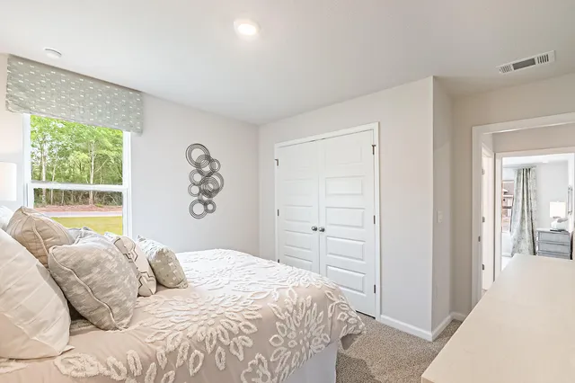 a bedroom with a large bed and a window