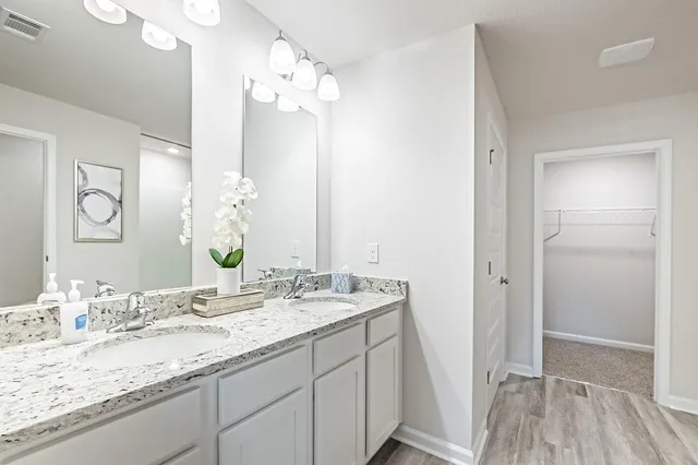a bathroom with a granite countertop sink mirror and vanity